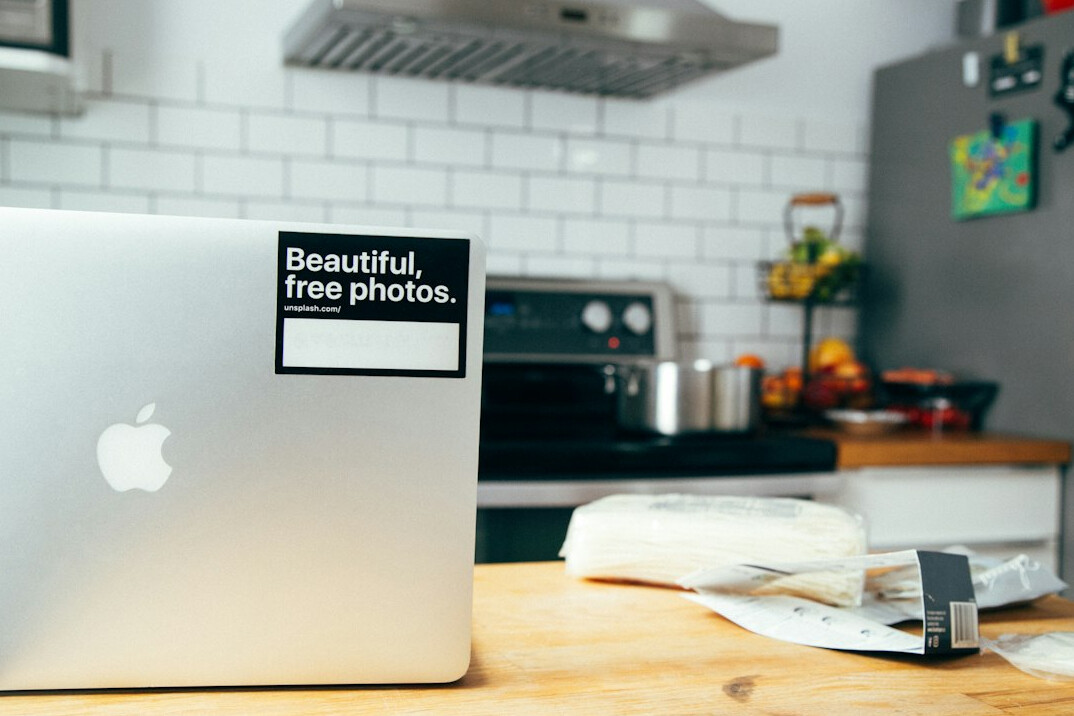 Investigative journalist's desk with notes, photographs, and a laptop