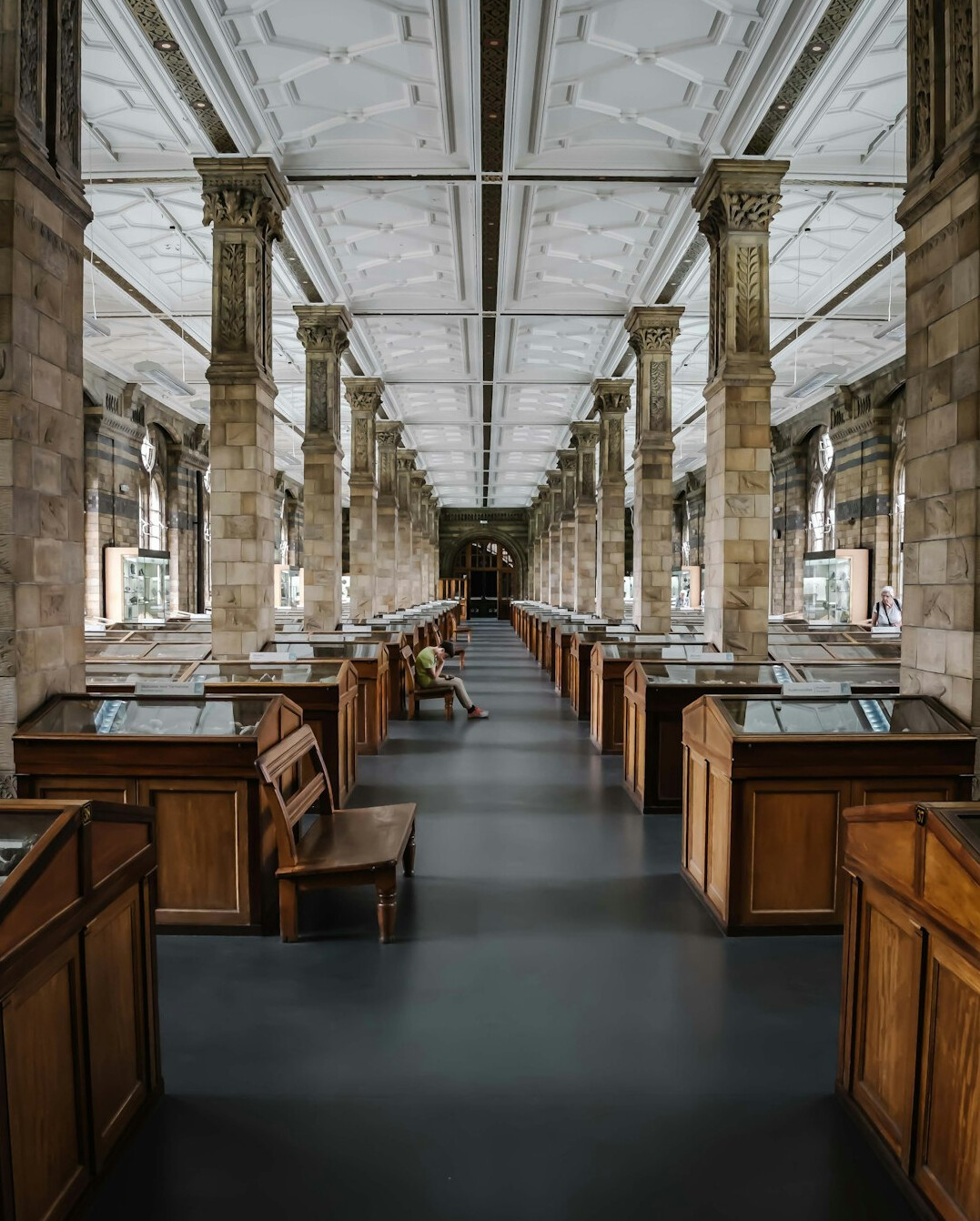 Wide interior of a historical archive reading room with long tables