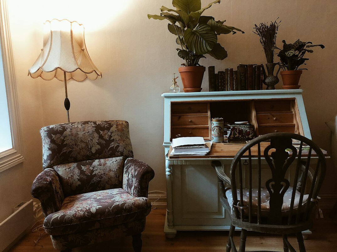 Writer's desk with a manuscript, pen, and reading glasses